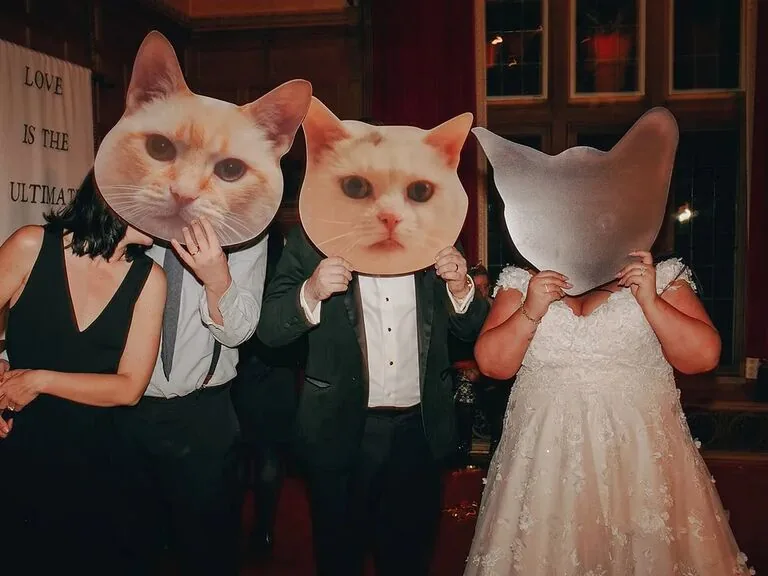 Wedding guests holding playful animal photo booth props